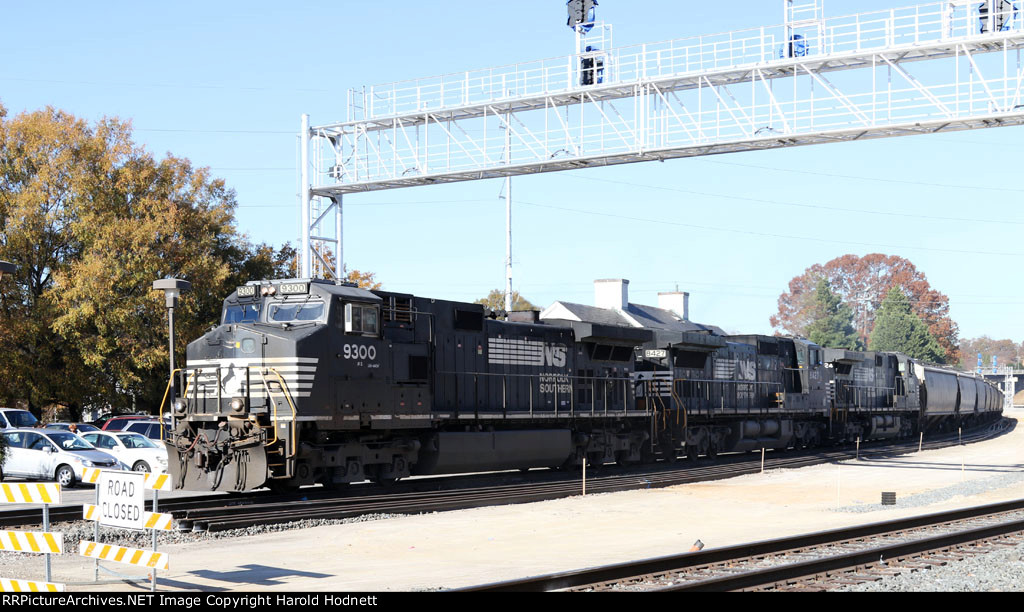 NS 9300 leads train 52X past the current passenger station and under the new signal bridge